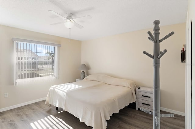 bedroom with wood-type flooring and ceiling fan