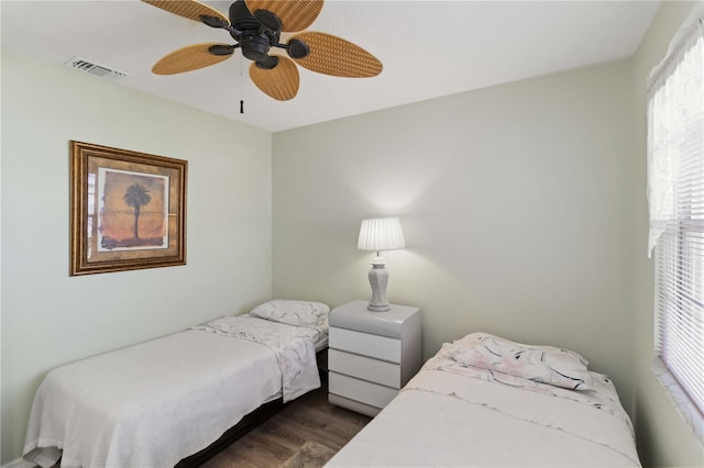 bedroom with dark wood-type flooring and ceiling fan