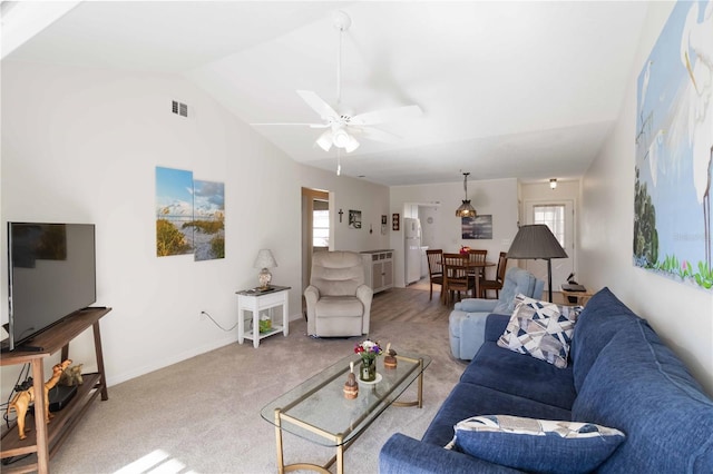 carpeted living room featuring ceiling fan, lofted ceiling, and a wealth of natural light