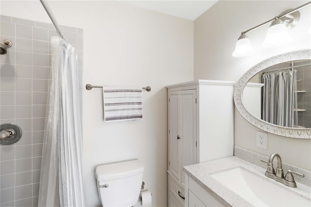 bathroom with vanity, toilet, and walk in shower