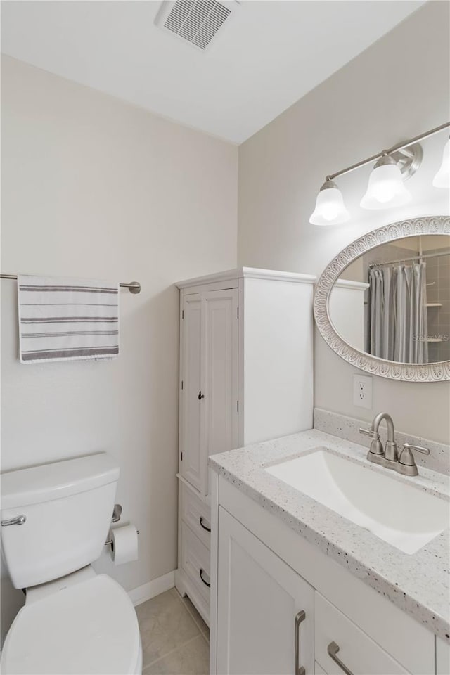 bathroom with tile patterned flooring, vanity, curtained shower, and toilet