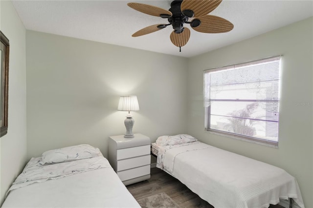 bedroom with dark hardwood / wood-style floors and ceiling fan