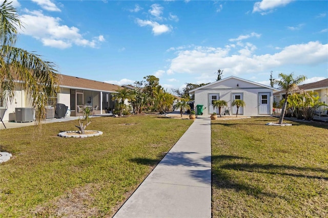 exterior space with cooling unit and a front lawn