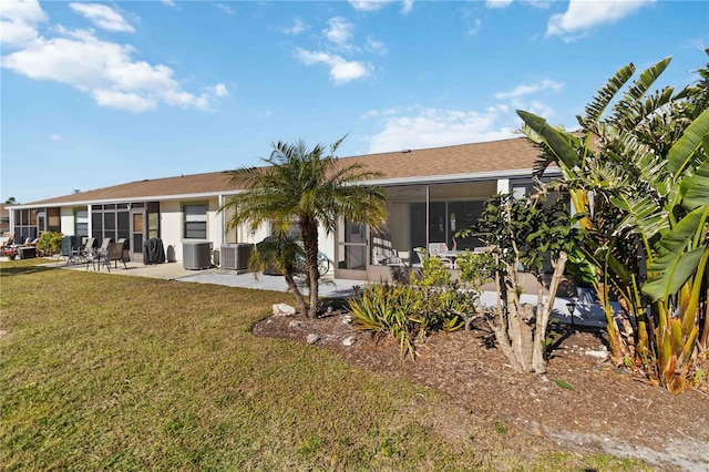 back of property featuring a yard, central AC, a patio area, and a sunroom