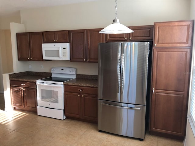 kitchen with pendant lighting, white appliances, and light tile patterned floors