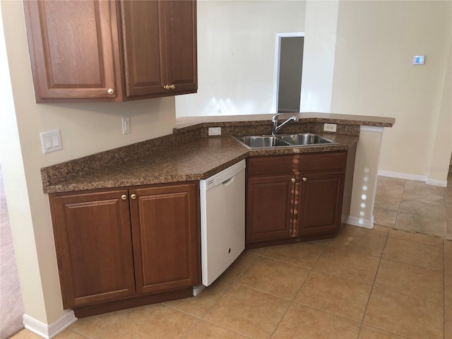 kitchen featuring sink, kitchen peninsula, dishwasher, and light tile patterned flooring