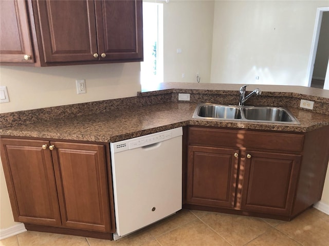 kitchen featuring sink, light tile patterned floors, kitchen peninsula, and dishwasher