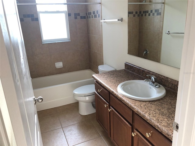 full bathroom with tile patterned flooring, vanity, tiled shower / bath, and toilet