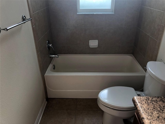 full bathroom with vanity, toilet, tiled shower / bath combo, and tile patterned flooring