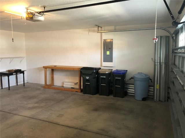 garage with a garage door opener and electric panel