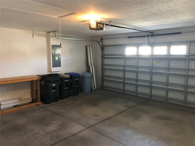 garage with a garage door opener and electric panel