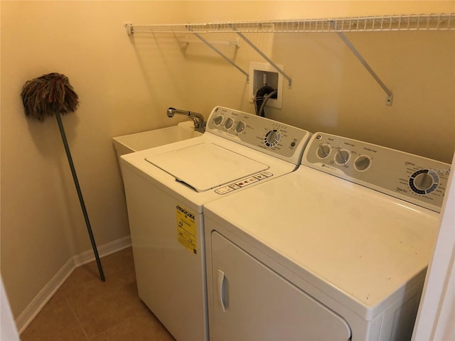 laundry room featuring tile patterned flooring and washing machine and dryer