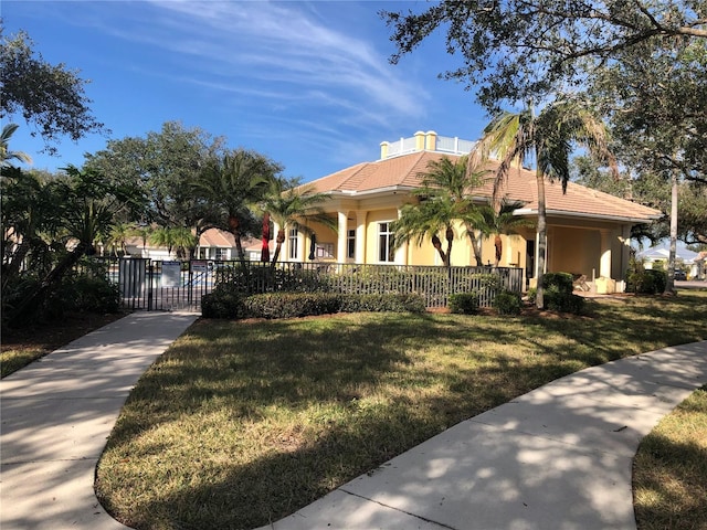 mediterranean / spanish-style home featuring a front lawn