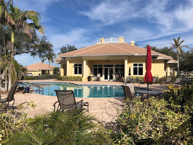 view of pool with ceiling fan and a patio