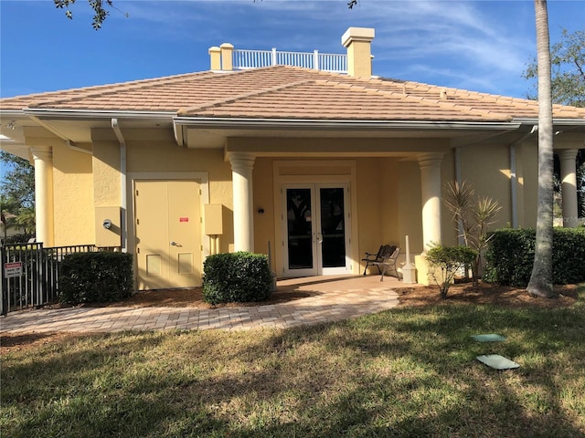 rear view of property featuring a yard