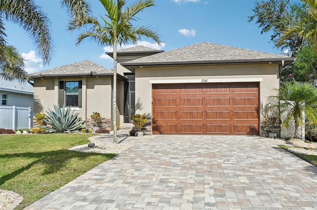 view of front facade with a garage and a front yard