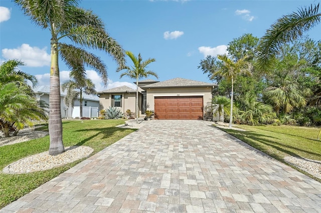 view of front of property with a garage and a front lawn