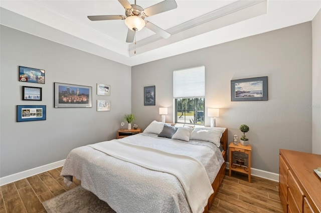 bedroom featuring ceiling fan and a tray ceiling