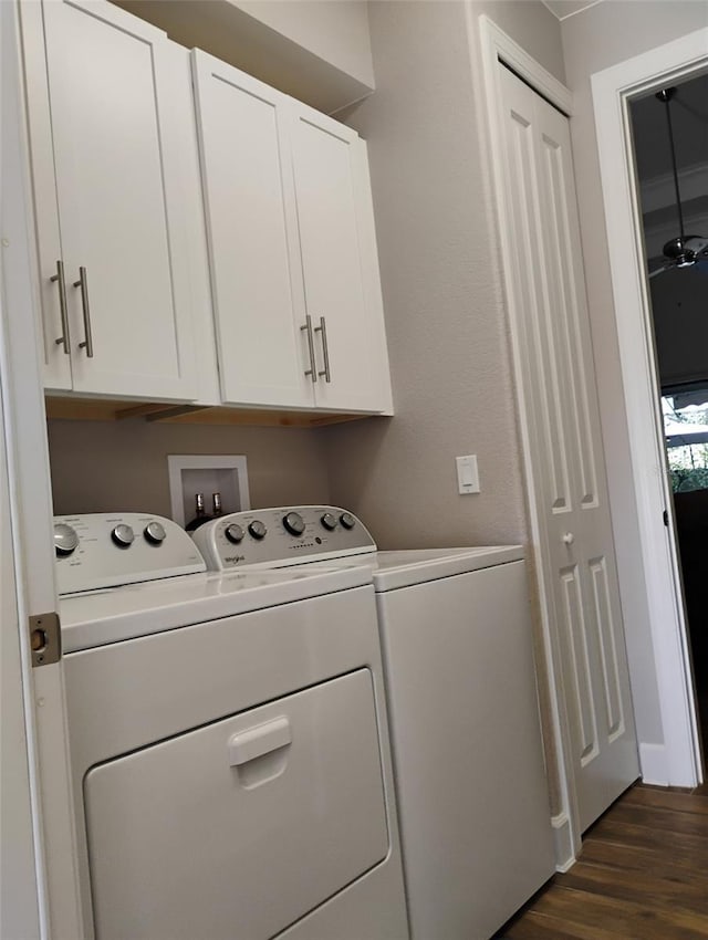 clothes washing area featuring cabinets, dark hardwood / wood-style flooring, and separate washer and dryer