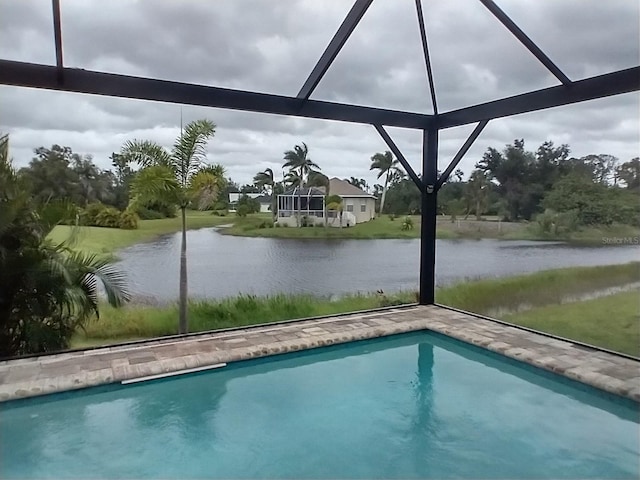 view of pool with a lanai and a water view