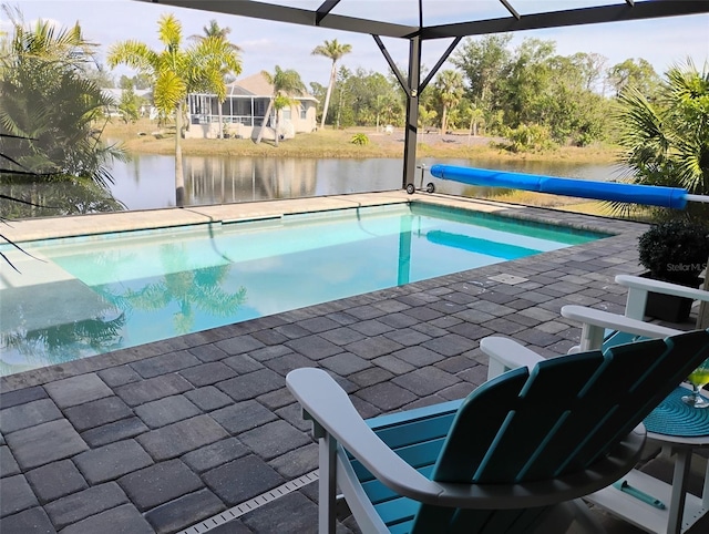 view of pool featuring a water view, a patio area, and a lanai