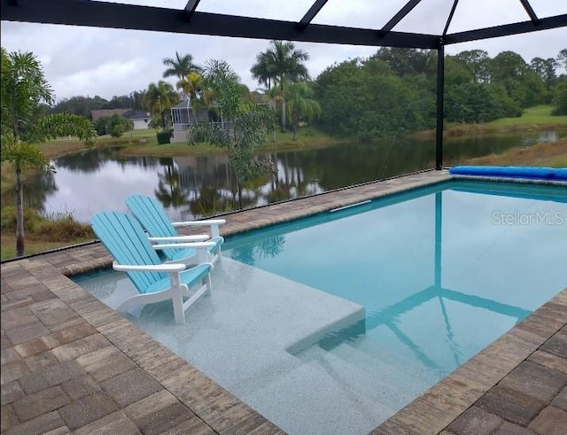 view of swimming pool with a lanai and a water view