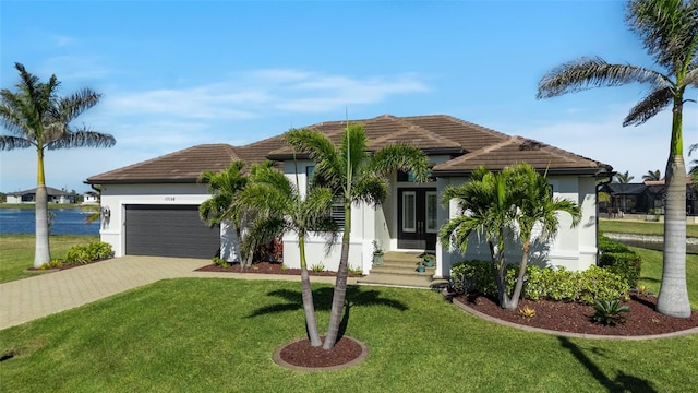 view of front facade featuring a garage and a front lawn