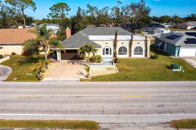 view of front of property with a garage and a front yard