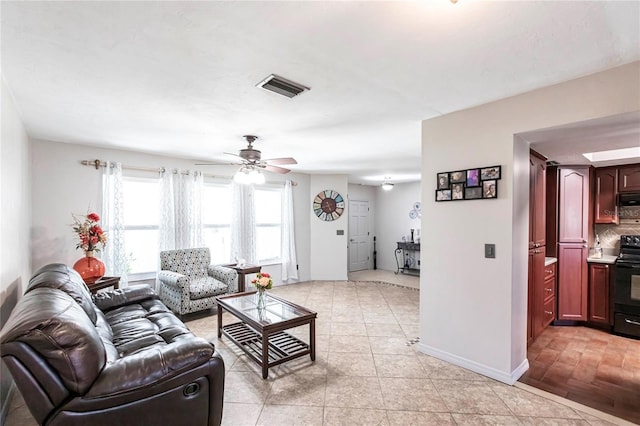 living room with ceiling fan and light tile patterned flooring