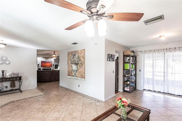 tiled living room featuring ceiling fan