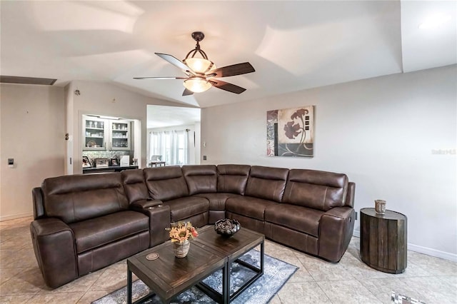 living room featuring lofted ceiling, light tile patterned floors, and ceiling fan