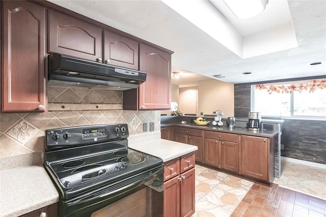 kitchen with black range with electric cooktop and decorative backsplash