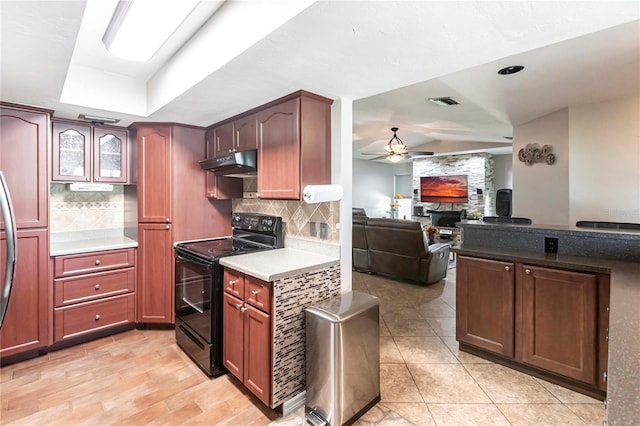 kitchen with a fireplace, decorative backsplash, ceiling fan, and black / electric stove