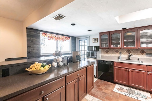 kitchen featuring black dishwasher, sink, and decorative backsplash