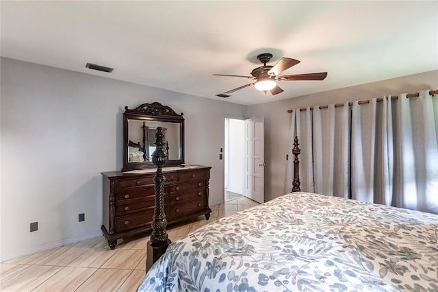 tiled bedroom featuring ceiling fan