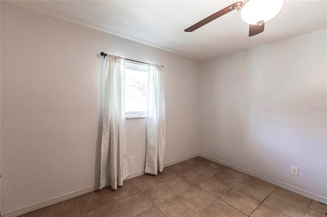 tiled spare room featuring ceiling fan