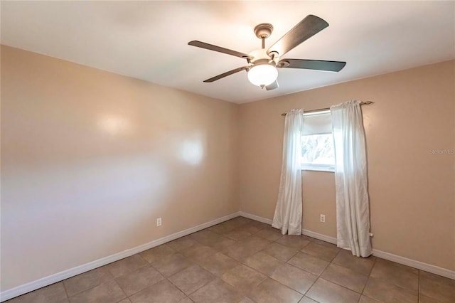 tiled spare room with ceiling fan