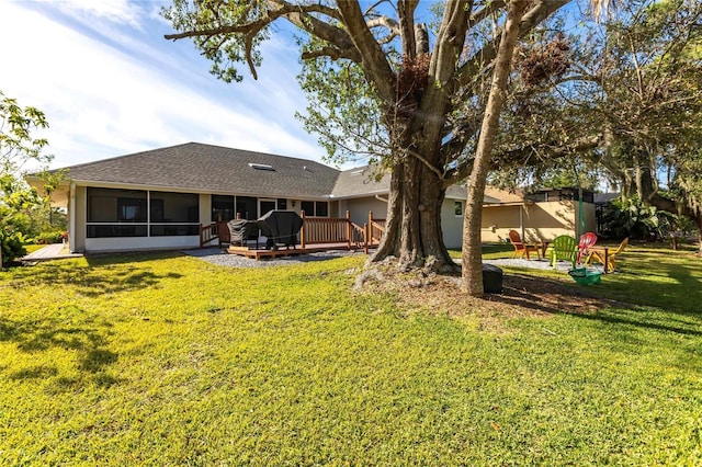 view of yard featuring a wooden deck and a sunroom