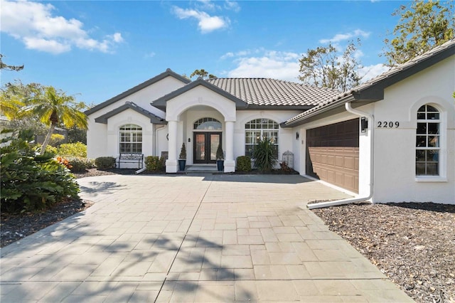 mediterranean / spanish-style home with a garage