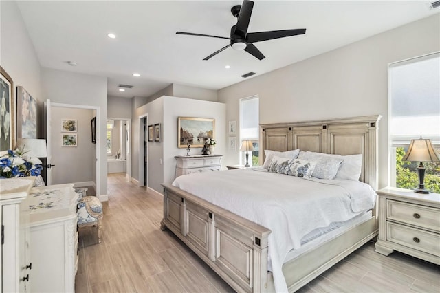 bedroom with ceiling fan, multiple windows, and light hardwood / wood-style flooring