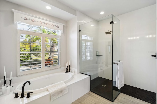 bathroom featuring shower with separate bathtub