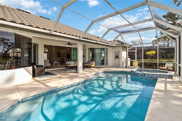 view of pool with ceiling fan, a patio, glass enclosure, an outdoor hangout area, and an in ground hot tub