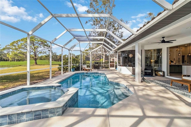 view of swimming pool featuring an in ground hot tub, ceiling fan, a patio area, and glass enclosure