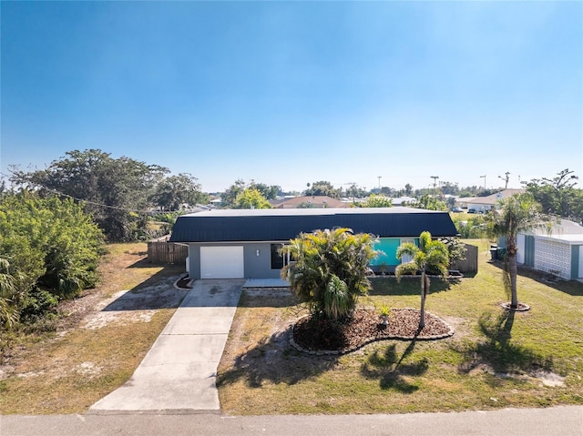 view of front of home with a garage and a front lawn