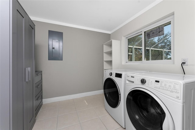 laundry area with light tile patterned floors, crown molding, washer and clothes dryer, and electric panel