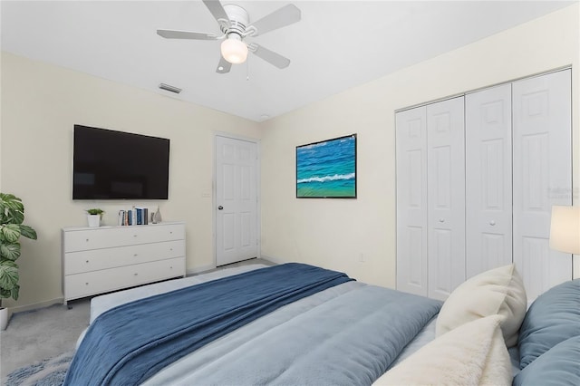 carpeted bedroom featuring ceiling fan and a closet