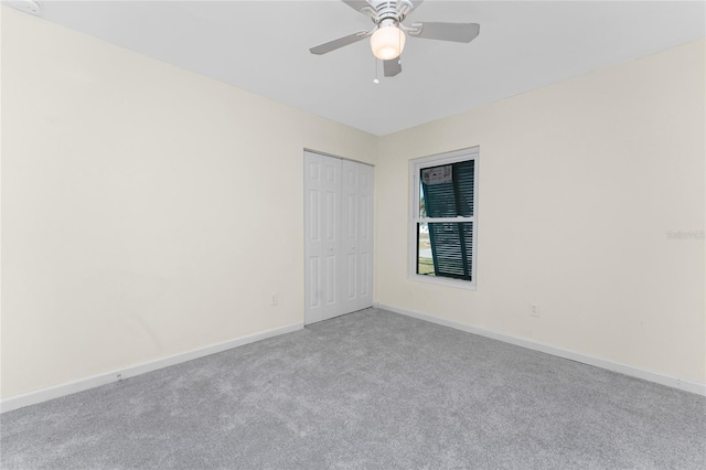 carpeted empty room with ceiling fan