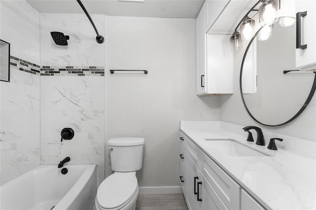 full bathroom with tiled shower / bath, vanity, and toilet