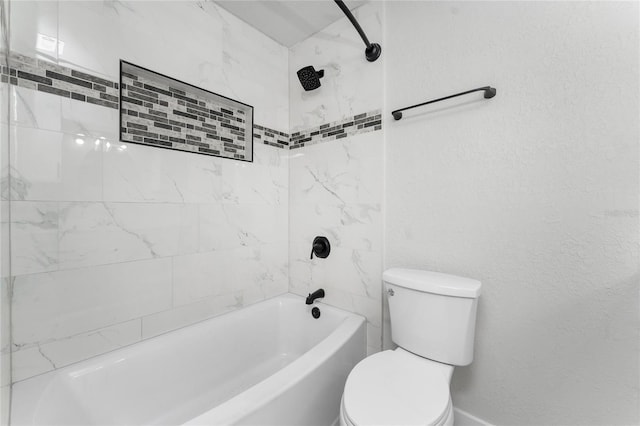 bathroom featuring tiled shower / bath and toilet