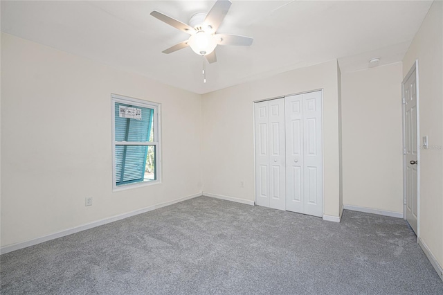 unfurnished bedroom with ceiling fan, a closet, and carpet